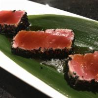 Goma Tuna Tataki · Lightly seared tuna with sesame seeds in a rich yuzu sauce and daikon sprouts.