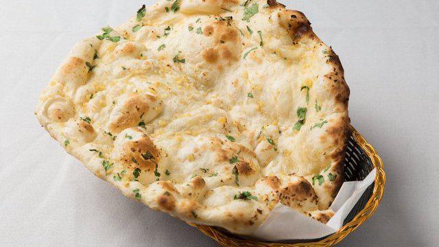 Garlic Naan · Leavened white flour bread brushed with fresh chopped garlic.
