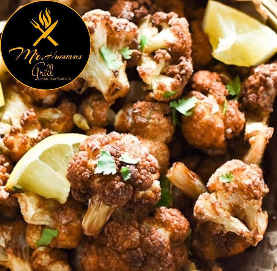 Fried Cauliflower · Thick pieces of cauliflower fried golden brown and topped with salt, pepper, lemon, garlic and parsley (served with tahini sauce).