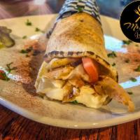 Chicken Shawarma Sandwich · Authentic-style sliced chicken, pickles and tomatoes topped with garlic sauce.