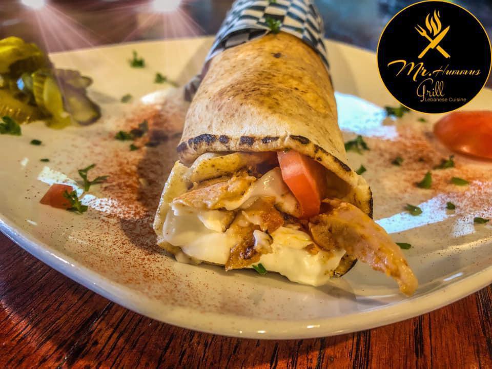 Chicken Shawarma Sandwich · Authentic-style sliced chicken, pickles and tomatoes topped with garlic sauce.