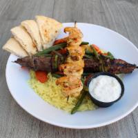 Surf and Turf Plate · Grilled shrimp skewer and steak skewer served on a bed of seasoned basmati rice with roasted...