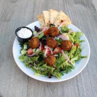 Falafel Salad · Spring mixed greens tossed with lemon tahini dressing and topped with chickpea falafel, red ...