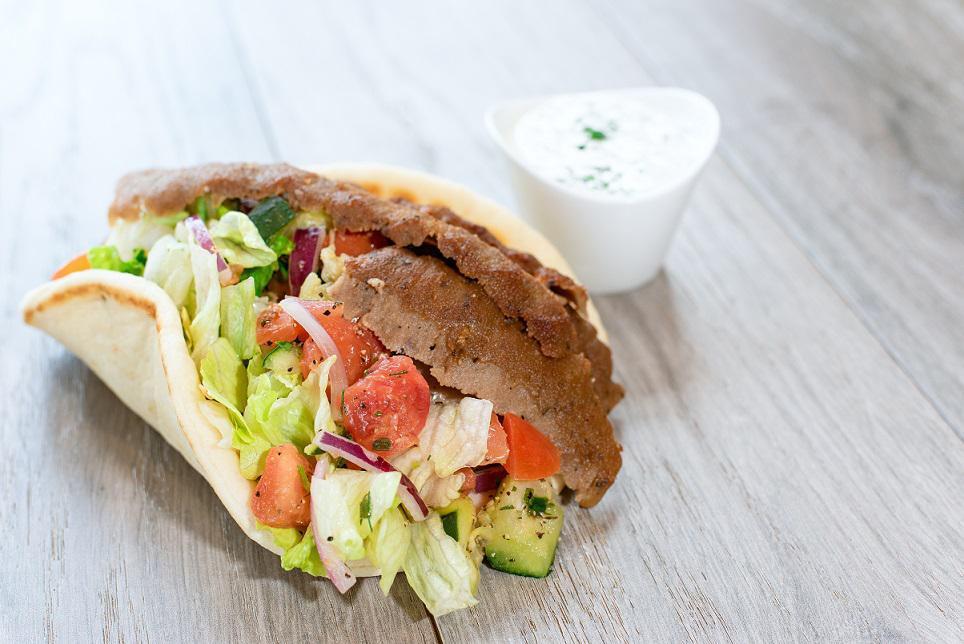 Classic Pita Sandwich · Hand-carved gyro or grilled chicken, lettuce, cucumber-tomato salad, red onion, lettuce, Greek dressing and tzatziki on a warm pita.