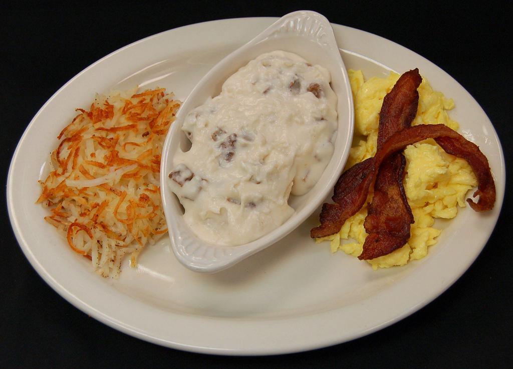Morning Story Biscuits and Gravy · Savory biscuit halves topped with our house made sausage gravy. Served with 2 farm fresh eggs any style, and our golden grilled hash browns.