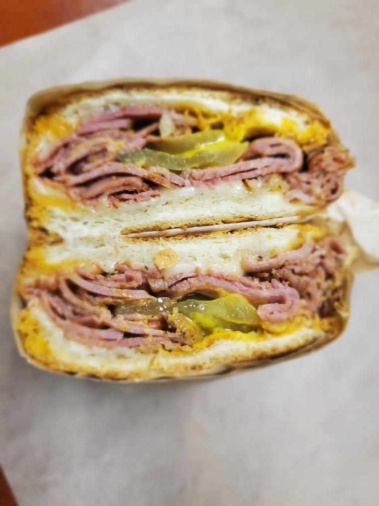Hot Pastrami Sub · Homemade pastrami fried on our griddle, and topped with melted Swiss pickles and choice of mustard. 