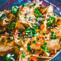 Nachos · Our homemade chips with choice of meat, beans, cheese, pico de gallo, onions, cilantro, and ...