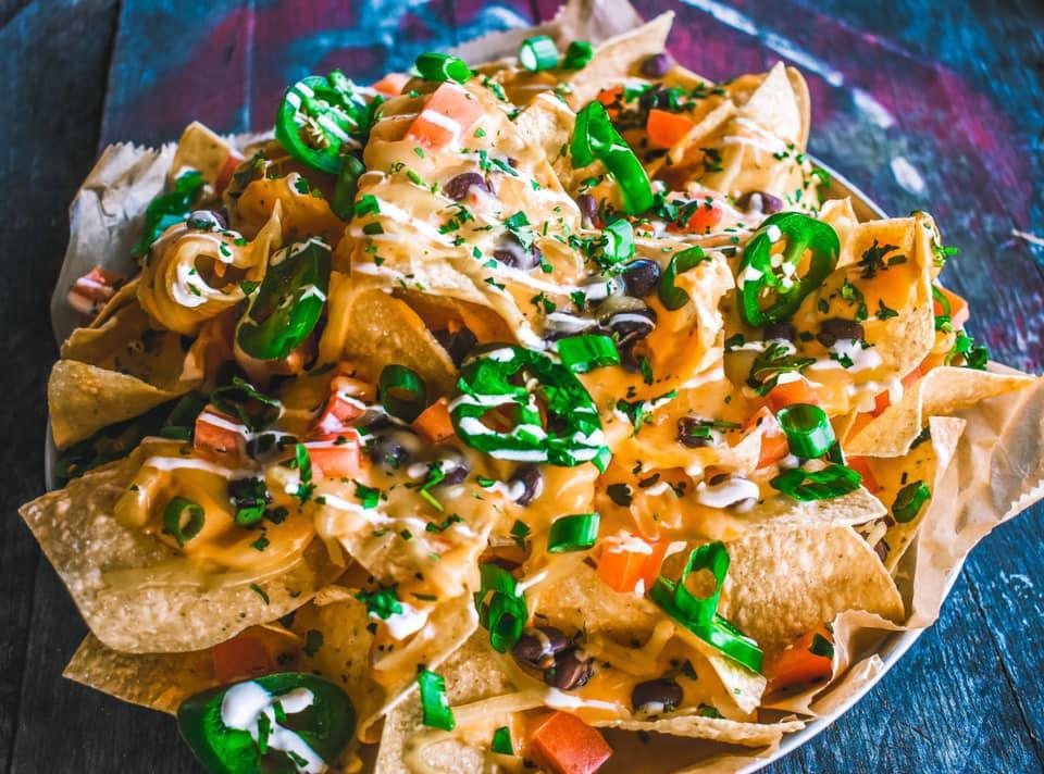 Nachos · Our homemade chips with choice of meat, beans, cheese, pico de gallo, onions, cilantro, and cilantro crema. 
