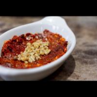Muhammara · A spicy mix of walnuts, bread crumbs, paprika, pepper paste and pomegranate juice.Served wit...