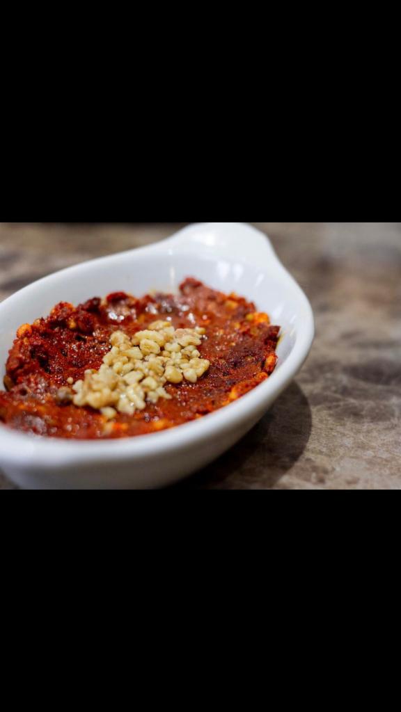Muhammara · A spicy mix of walnuts, bread crumbs, paprika, pepper paste and pomegranate juice.Served with pickles and pita.