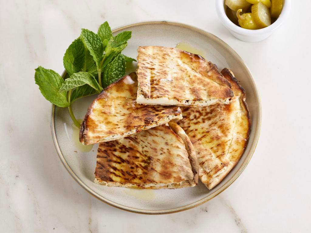 Grilled Cheese Pita · New cheese marinated with mint, red pepper and e.v.o.o., flakes and grilled.