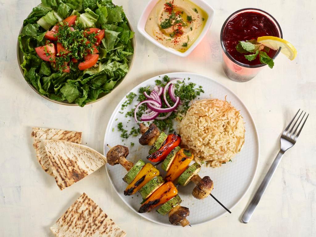 Veggie Kebab · 3 Skewers. Grilled mushrooms, Italian squas and red bell peppers.  Served with rice, hummus, salad and pita. Vegetarian.
