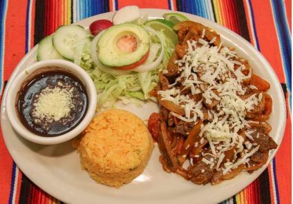 Bistek a la Mexicana Platillo · Sautéed stake with onions, tomatoes, jalapeños, served with rice and beans, a small side salad and corn tortillas 