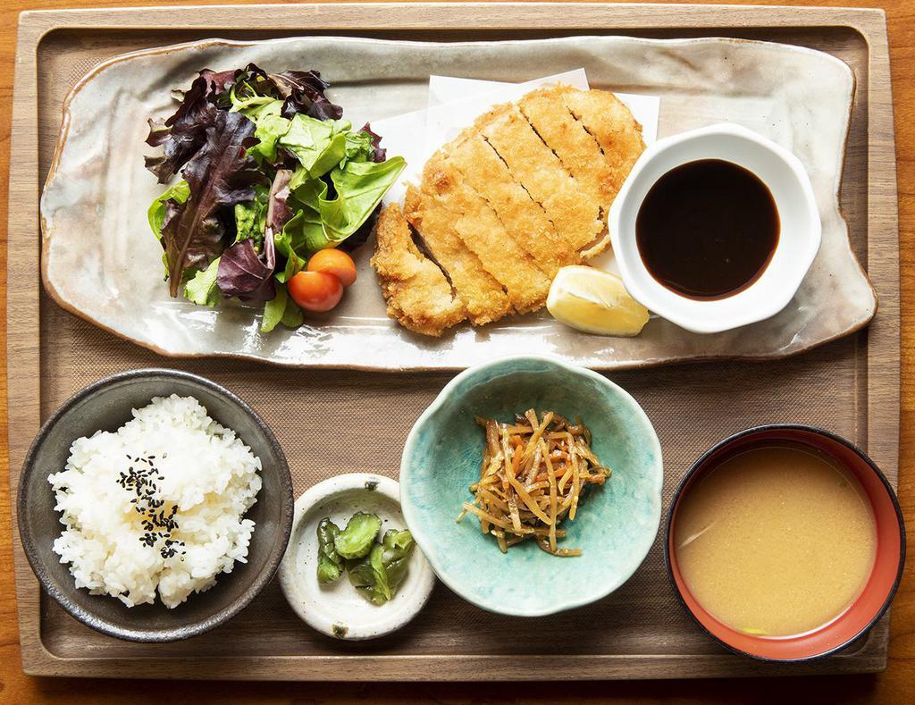 Tonkatsu Bento Box · Pork cutlet, shredded cabbage, and side of tonkatsu sauce.