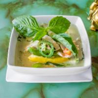 41. Green Curry · Green curry with coconut milk, eggplant, bamboo shoots, bell peppers, peas, and basil leaves...