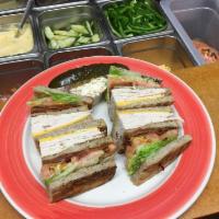 Turkey Club Sandwich · Fresh sliced turkey breast, smoked bacon, lettuce, tomato, American cheese, and mayonnaise.