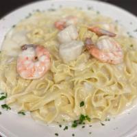 Seafood Alfredo  · Shrimp, scallops, and crab meat over fettucine.