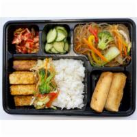 Tofu Bento Box   · Includes veggie spring rolls, japchae noodle stir fried vermicelli with vegetables, 2 side d...