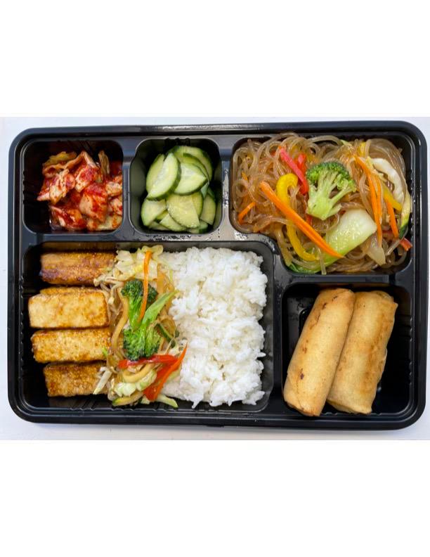 Tofu Bento Box   · Includes veggie spring rolls, japchae noodle stir fried vermicelli with vegetables, 2 side dishes (picked kimchi, picked cucumber) with choice of rice.Miso soup (optional). Vegetarian.