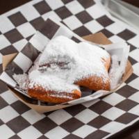Beignets (4 Pieces) · 4 Pieces Fried Beignet Dough Sprinkled with Powedered Sugar.