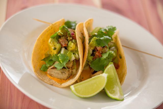Crispy Fish Tacos · Tomato-avocado salsa, Napa cabbage,cilantro, chipotle aioli, flour or corn tortillas, served with spiced vegetarian beans.