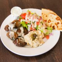Falafel Plate · 5 pieces of falafel with side salad, hummus, 1/2 pita bread and tahini sauce.