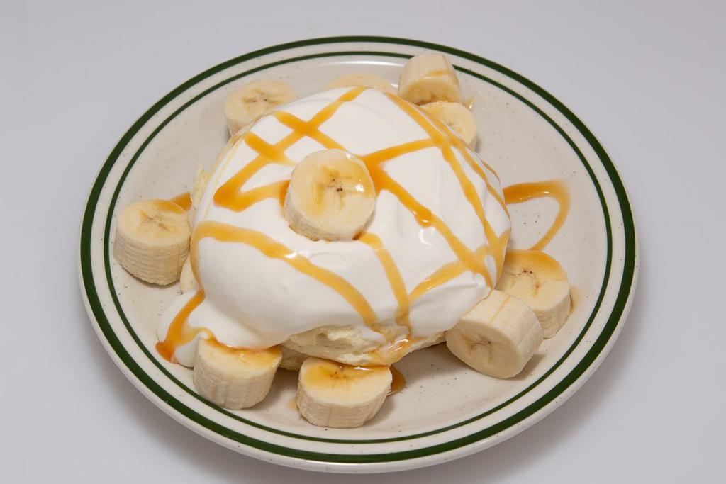 Caramel Banana Souffle Pancake · Fluffy pancake with banana, caramel drizzle and cream.
