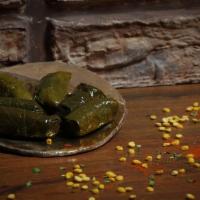 Dolmeh · Cooked grape leaves filled with rice, split peas and fresh herbs . 














