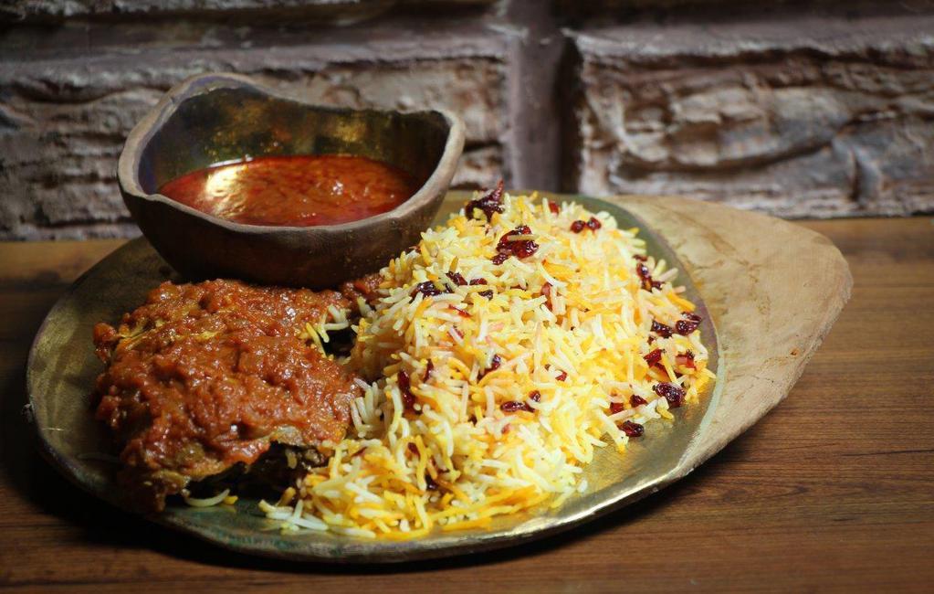 Zereshk Polo with Chicken · A tantalizing taste of barberries and saffron in a mixture of Basmati rice served with a braised chicken( breast or thigh ) cooked in a saffron tomato sauce.