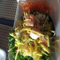 11. Mango Salad · Sliced green mango with shrimp, calamari mixed with red onion, chili, cashew nuts, 
and lemo...
