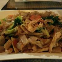 77. Pad Kee Mow · Pan fried wide rice noodle with choice of chicken or pork mixed with a dash of chili, egg, b...