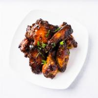 Chipotle BBQ Wings · Charr grilled wings cooked with chipotle bbq sauce.