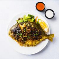 Grilled Whole Pomfret Fish Platter · Whole pom fish marinated with lemon and herbs.