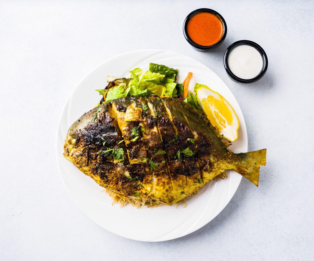 Grilled Whole Pomfret Fish Platter · Whole pom fish marinated with lemon and herbs.