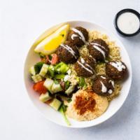 Falafel & Hummus Bowl · Falafel, green pea hummus, rice, Greek salad, seasonal greens, and white sauce.