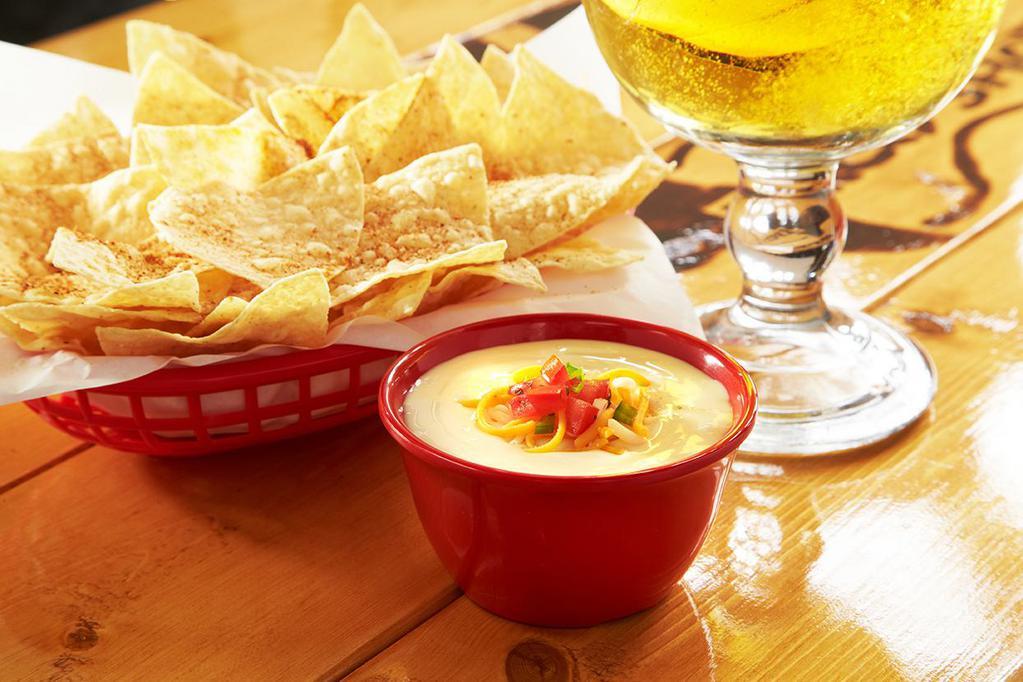 Chips and Queso with Beef · Basket of fresh tortilla chips seasoned with Fuzzy dust, and served with queso with special ground beef.