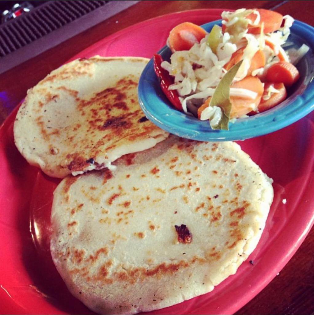 Pupusas Plate · 2 thick corn mill stuff tortillas with pork and cheese (chicharron) or just cheese. side of our homemade curtido ( pickled cabbage)