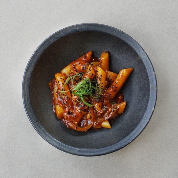 Ddukkbokki · Rice cakes and scallions sautéed in a sweet and spicy chili sauce.