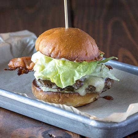Sellwood Burger  · Beef, bacon, beecherʼs aged cheddar, caramelized onions, butter lettuce, aioli, on brioche. Add salad for an additional charge.