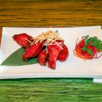 Thai Style Wings · Thai style chicken wings with a side of Sriracha sauce.