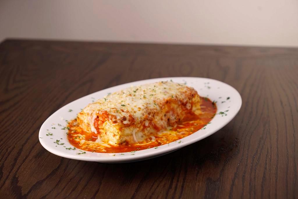 Baked Lasagna · Baked ribbon noodles four cheese blend with marinara sauce. Served with 3