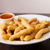 Breadsticks · Fried pizza dough strips covered with garlic butter and served with a cup of marinara sauce.