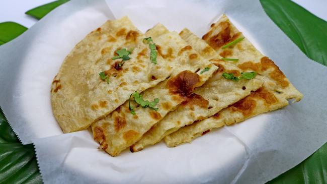 Garlic Naan · Fresh tandoor baked white flour garlic bread.