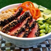 Tuna Poke Bowl · Sesame seared tuna, avocado, chickpea, slaw, brown rice, carrots, cucumbers, edamame and pic...