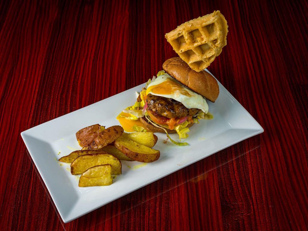 Cheat Day Breakfast Burger · Lean ground beef patty, lettuce, tomato, pickled onions, cheddar cheese, turkey bacon, sunny side up egg and maple mayo on a whole wheat kaiser roll. Served with 1/4 of a Belgian waffle and roasted potatoes or house salad.