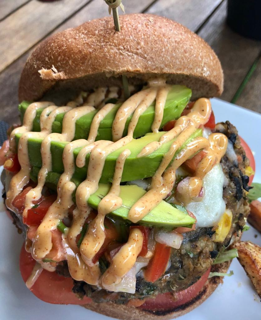 Tex-Mex Vegan Burger · Homemade black bean, quinoa and corn patty, served with lettuce, tomatoes, pico de gallo, avocado and vegan chipotle mayo. Served on a whole wheat kaiser roll with roasted potatoes or house salad. Vegan.