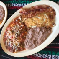 7. Huevos Rancheros Plate · 2 over easy eggs mounted on crispy corn tortillas topped with ranchero sauce and cheese, ser...
