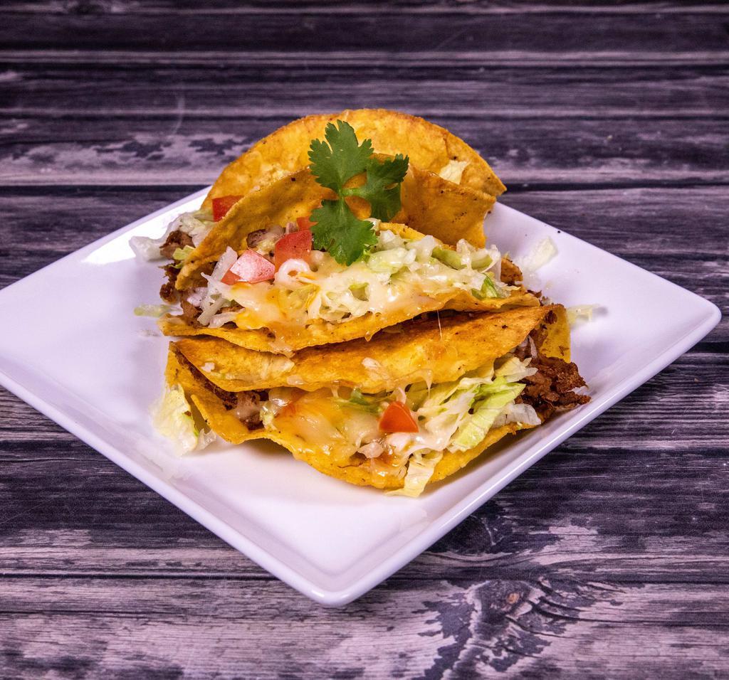 26. Tacos Deshebrada · 3 crunchy shredded beef tacos with fresh lettuce, tomatoes and shredded cheese served  with rice and beans or 4 tacos only.