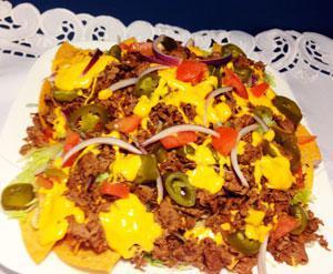 Nachos Supreme · Served with steak, red onions, fresh tomatoes, lettuce, jalapeno, cheddar and sour cream. Hot and spicy.