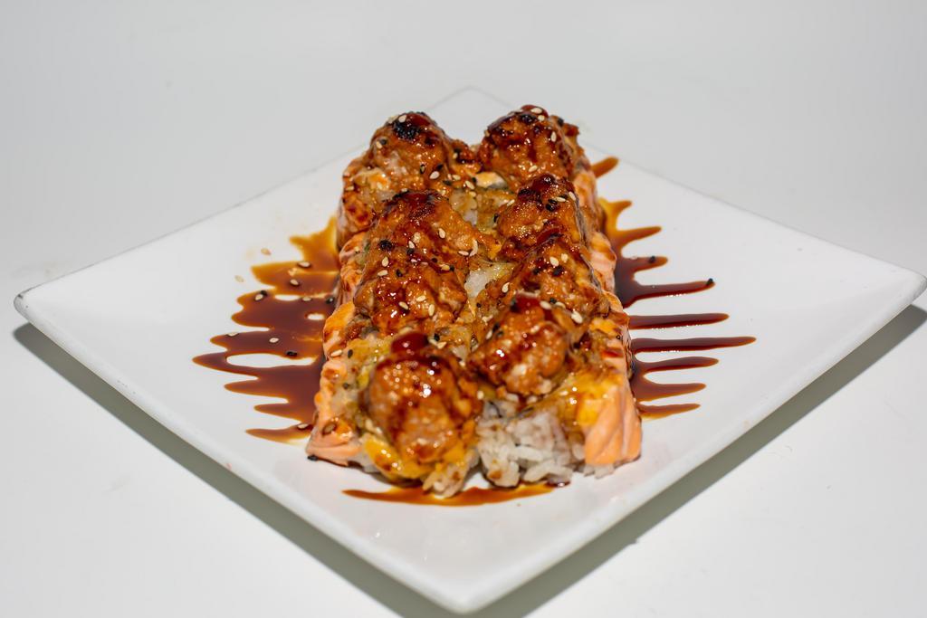 Baked Mountain Roll · Inside: crabmeat, cucumber and avocado. Outside: salmon and spicy tuna. Served with sauce. Spicy.